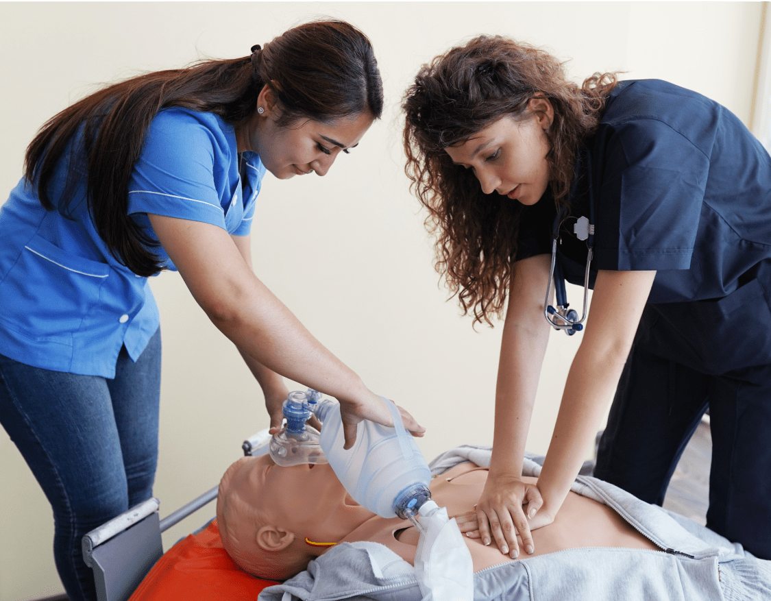 Img (6) Two female nursing students practicing CPR on a CPR dummy
